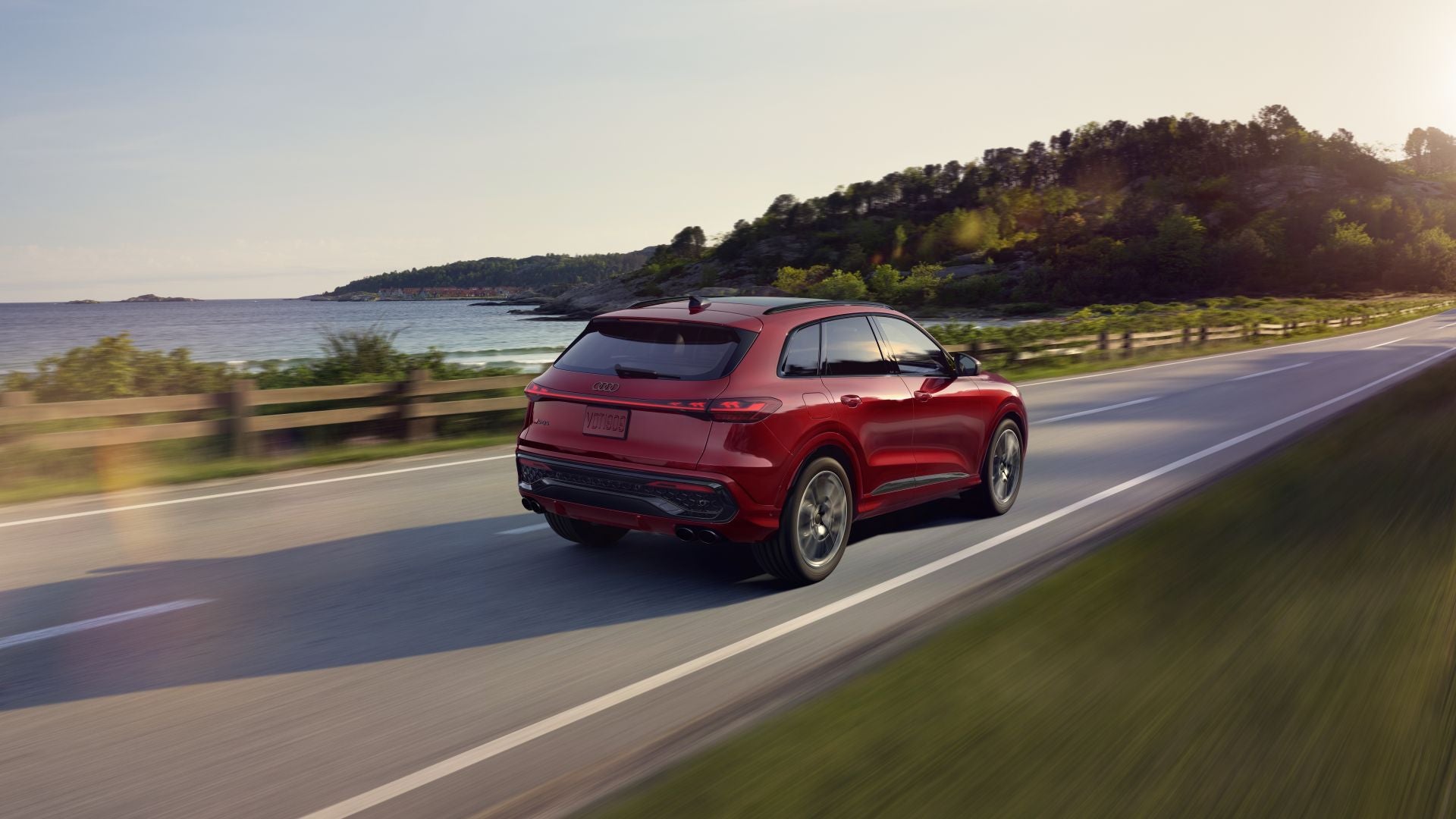 Rear profile view of an Audi SQ5 accelerating.